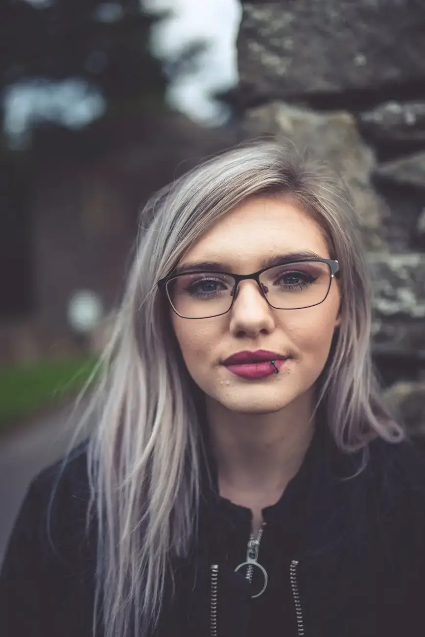 a close up photo of a woman wearing eyeglasses