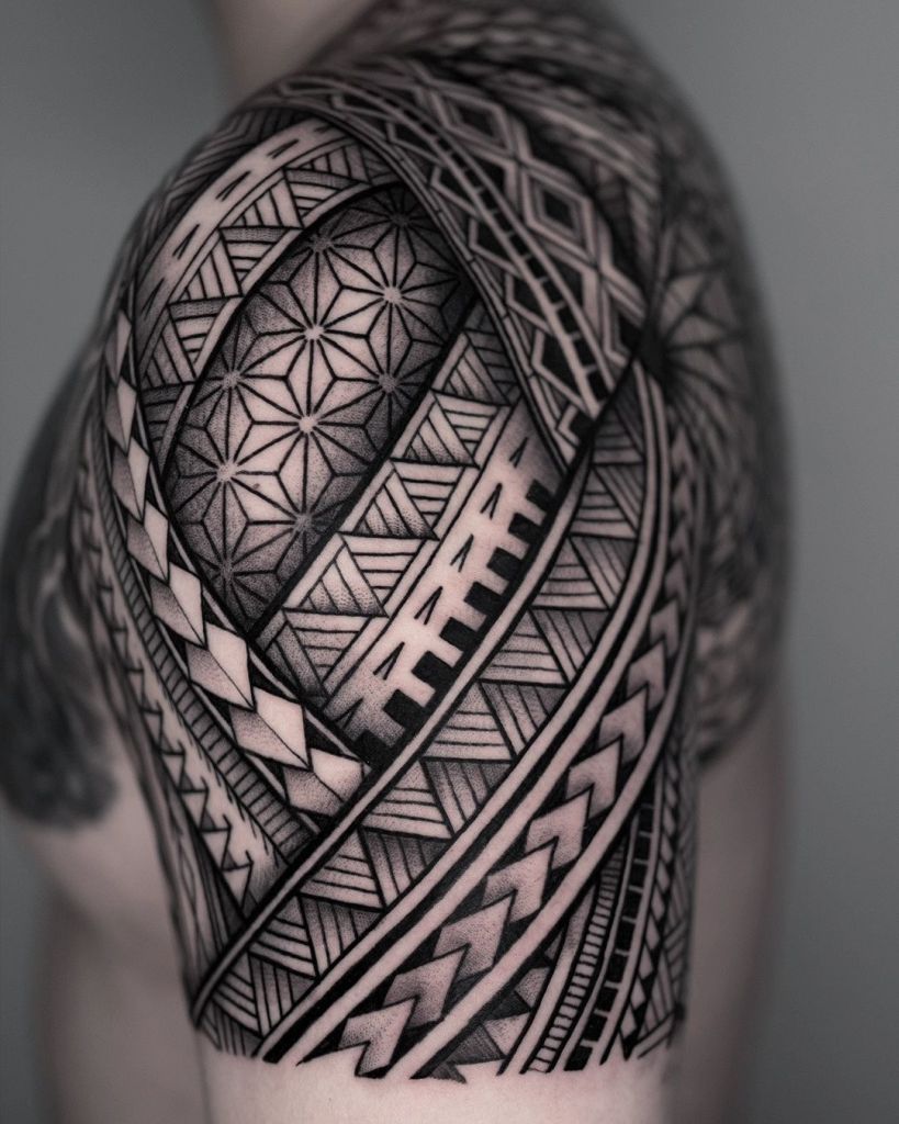 A traditional Māori tattoo design showcasing intricate koru and spiral patterns on a forearm.